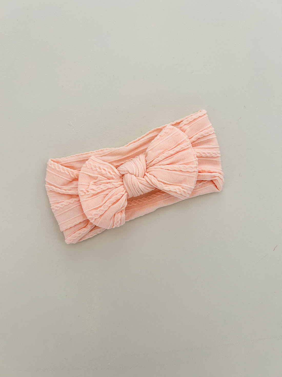 KNOT BOW CABLE KNIT HEADBAND - PEACH